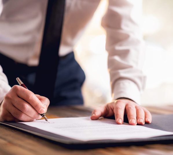 Businessman Signing An Official Document